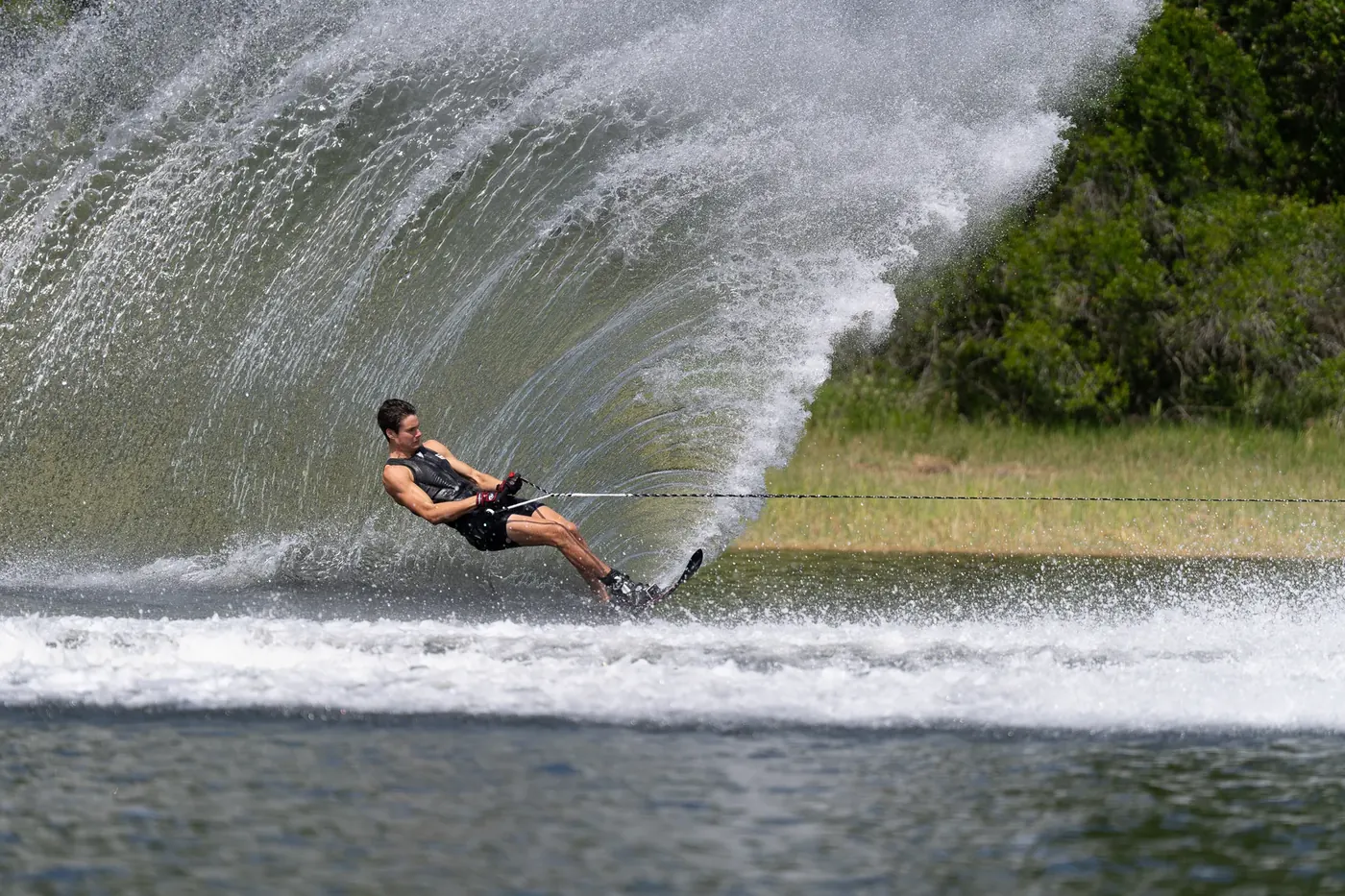 Slalom skier carving behind a Ski Nautique